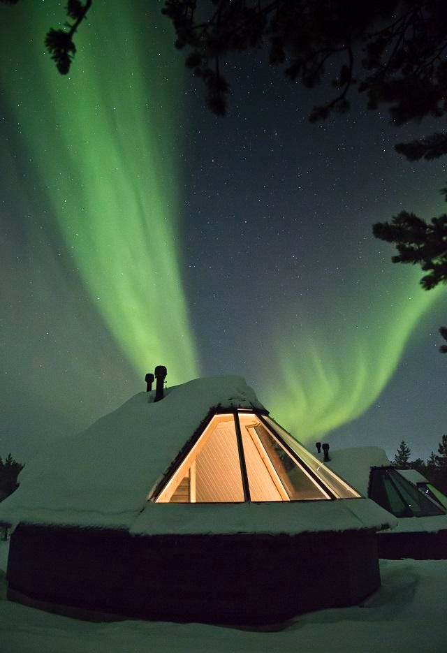Aurora over a wilderness lodge in northern Finnish Lapland