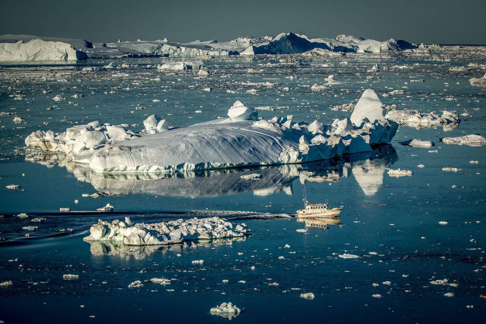A passenger boat cruising the Disko Bay ice near Ilulissat