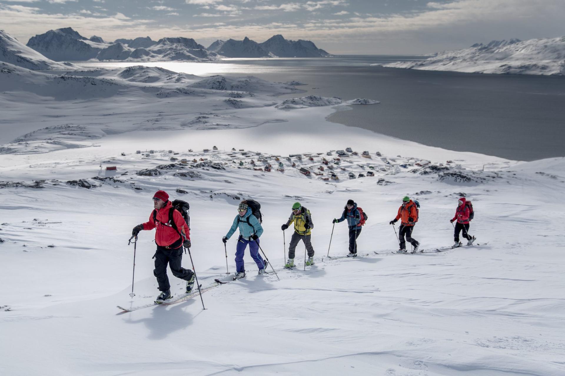 A ski touring group climbing above Kuummiut, East Greenland