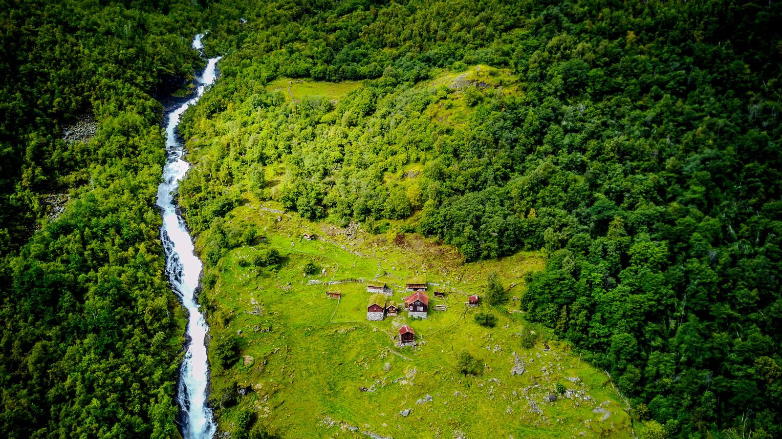 Aerial view over a green Norwegian valley and fjord