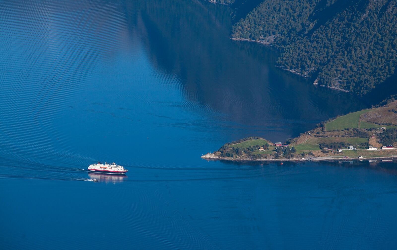 A ship on the Hjørundfjord between steep Sunnmøre mountains, Norway
